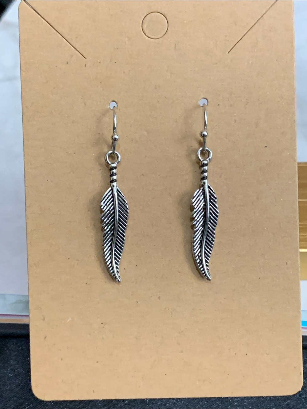 Silver tone feather earrings